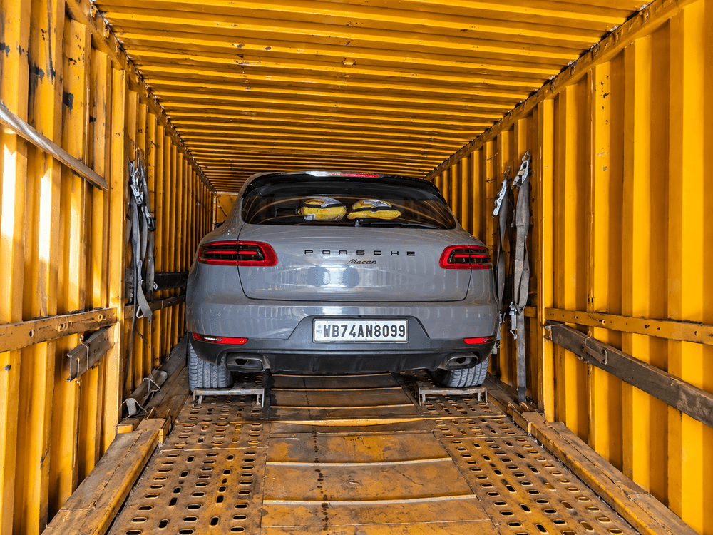 Car being safely loaded onto vehicle transport carrier truck