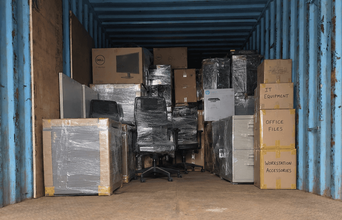 Office equipment and desks being packed for commercial corporate move